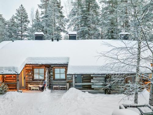 a log cabin with snow on the roof at Holiday Home Luppokero 2 by Interhome in Pyhätunturi