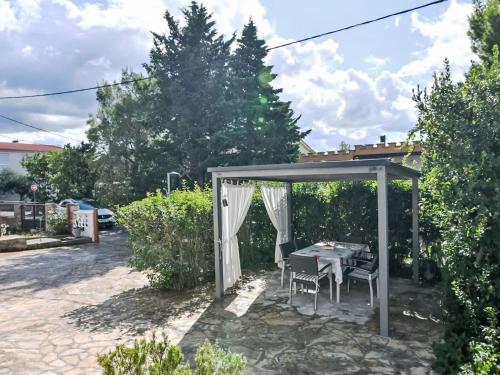 a table and chairs under a gazebo at Holiday Home Marija by Interhome in Rovanjska