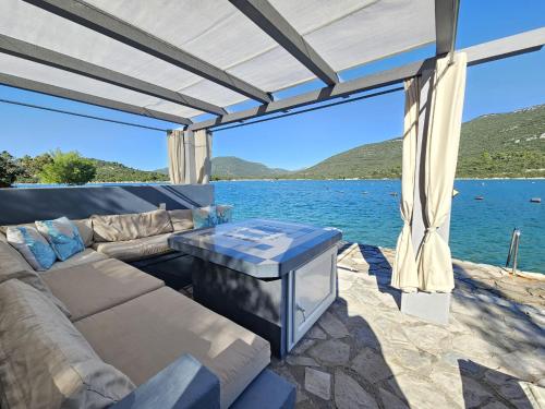 a living room with a couch and a view of the water at Apartment Waterfront Oasis-3 by Interhome in Mali Ston