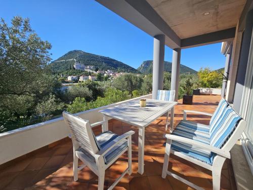 a patio with a table and chairs on a balcony at Apartment Waterfront Oasis-1 by Interhome in Mali Ston