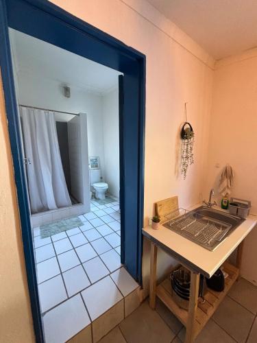 a bathroom with a sink and a table in a room at Buffelsrivier Farm Stay in Laingsburg