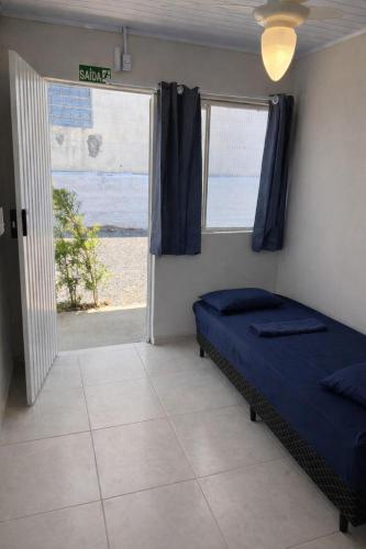a bedroom with a bed and a large window at Morá 2 Coliving in Cachoeirinha