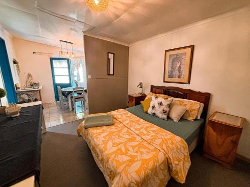 a bedroom with a bed and a living room at Buffelsrivier Farm Stay in Laingsburg