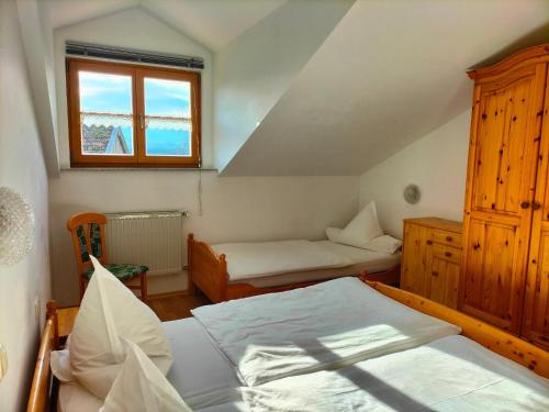 a bedroom with two beds and a window at Ferienhof Wolf in Viechtach