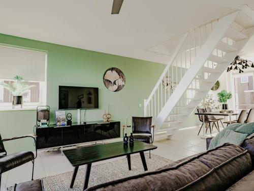 a living room with a couch and a table at Apartment Oostergeest 2 by Interhome in Uitgeest