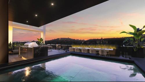 a swimming pool in a house with a sunset at Luxury Apartments with View & Indoor Heated Pool in Montréal