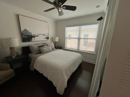 a bedroom with a bed and a ceiling fan at Beachside One Bedroom Condo with Pool Access in Hollywood