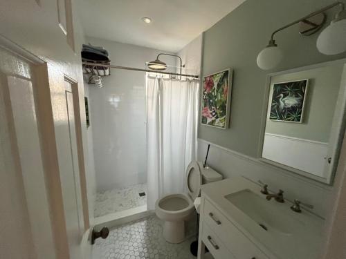 a bathroom with a toilet and a shower and a sink at Beachside One Bedroom Condo with Pool Access in Hollywood