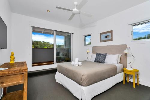 a bedroom with a bed and a window at Stonecutters 2 in Byron Bay