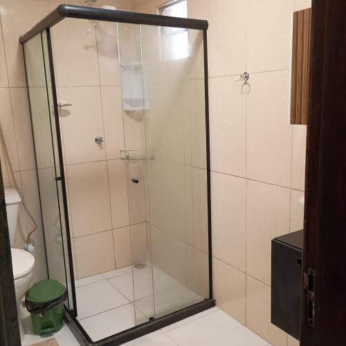 a shower with a glass door in a bathroom at Paim`s Village Itacaré in Itacaré