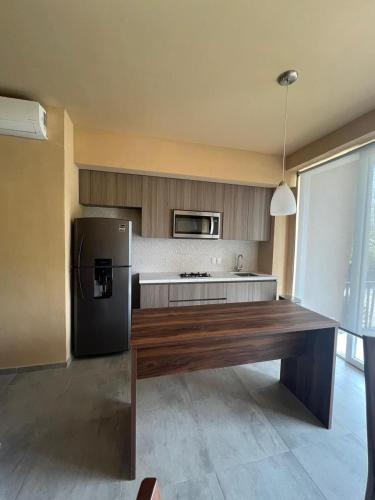 a kitchen with a refrigerator and a table in it at Mangle09 in Puerto Vallarta