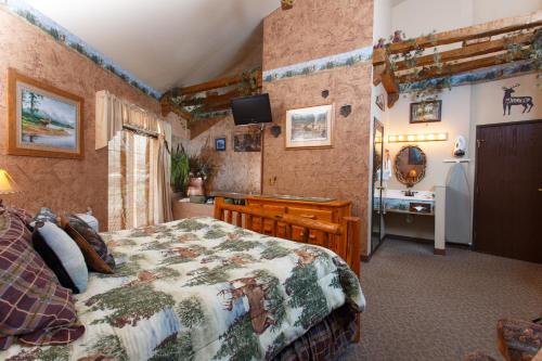 a bedroom with a bed and a sink in it at Hotel J Green Bay in Green Bay