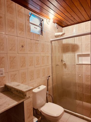 a bathroom with a toilet and a shower at Pousada Sossego Boipeba in Ilha de Boipeba