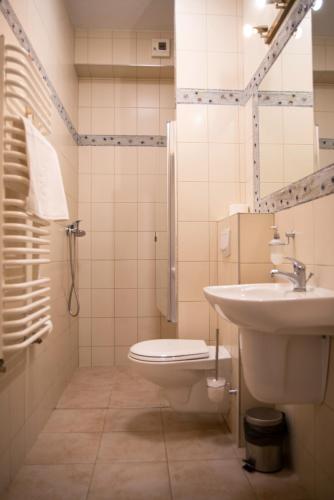 a bathroom with a toilet and a sink at Villa FOREST in Poznań