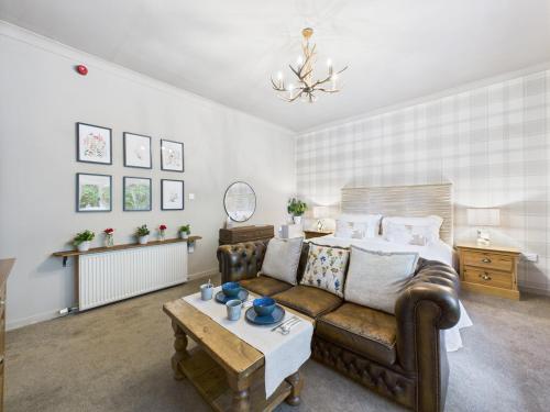 a living room with a couch and a table at Glenshee Suite, Beechtree Cottage in Kirkmichael