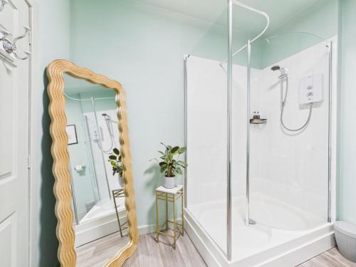 a bathroom with a shower and a mirror at Glenshee Suite, Beechtree Cottage in Kirkmichael