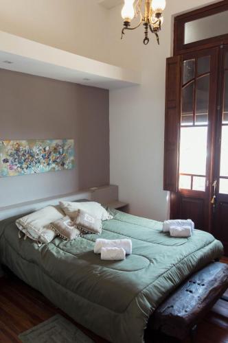 a bedroom with a large bed with towels on it at Mayo apparts in Esperanza