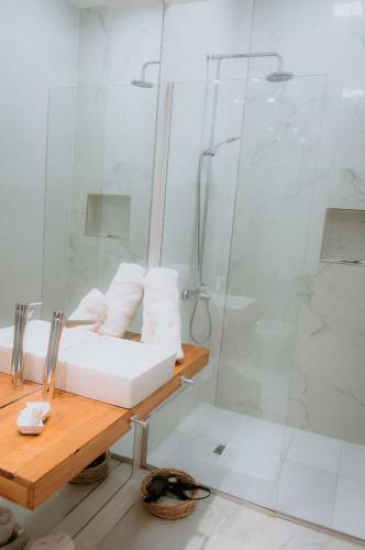 a bathroom with a shower and a white sink at Mayo apparts in Esperanza