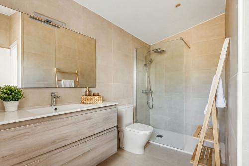 a bathroom with a sink and a toilet and a shower at Villa Maite by Escape Home in Binibeca