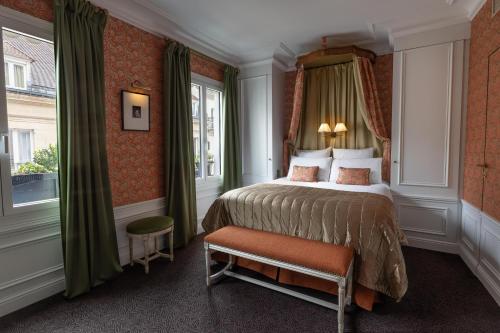 a hotel room with a bed and a window at Hôtel De Buci in Paris