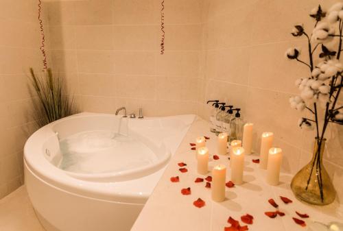 a bathroom with a toilet and candles on a counter at La Parenthèse Yssoirienne - Balnéo - Vidéoprojecteur in Issoire