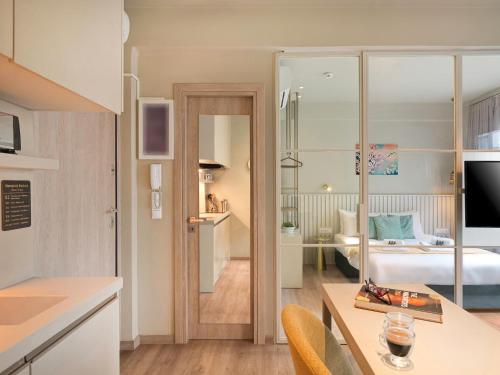 a kitchen and a living room with a bedroom at Karitsi Suites in Athens