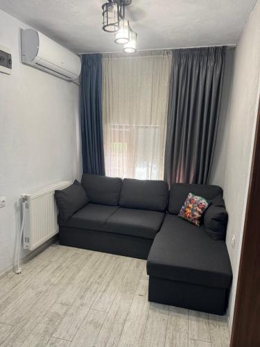 a living room with a couch and a window at Berta Gardens 2 in Sandanski