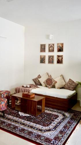 a living room with a couch and a coffee table at Indran in Chhatikara