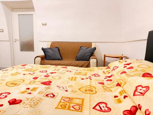 a bed with a blanket with hearts on it at Scorcio Sul Mare in Gallipoli