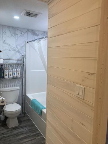 a bathroom with a toilet and a bath tub at Cougar Mountain Lodge and Resort Cabin Rentals in Valemount
