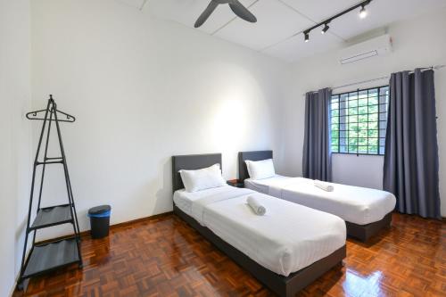 a room with two beds and a ladder in it at Gathering Double Storey House-10pax in Kampong Pantai Batu Hitam