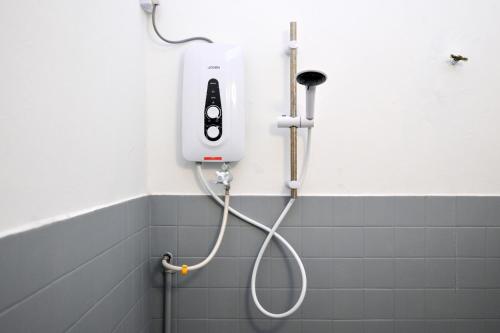 a white shower in a bathroom with a whiteitizer at Gathering Double Storey House-10pax in Kampong Pantai Batu Hitam