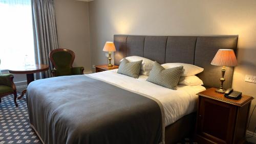 a hotel room with a large bed with pillows at Meadowlands Hotel in Tralee