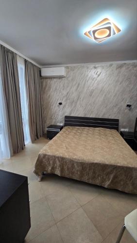 a bedroom with a large bed in a room at Apart-Hotel Argo in Lozenets