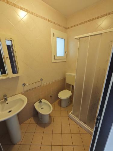 a bathroom with a sink and a toilet and a shower at Residence Sporting in Rosolina Mare