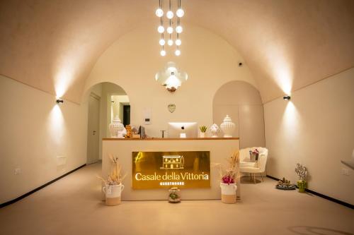 a large room with a counter with a sign in it at Casale della Vittoria - Guest House in Taranto