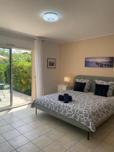 a bedroom with a bed and a sliding glass door at Villa Sole Flats in Saint Paul de Vence