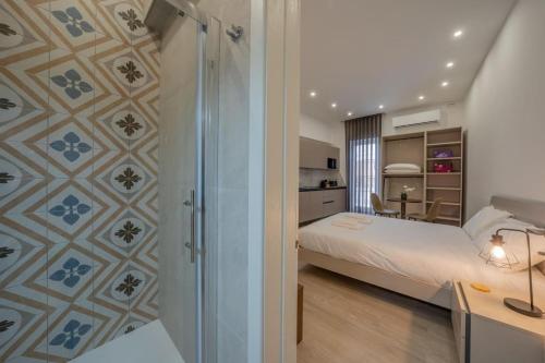 a hotel room with a bed and a bathroom at Urban Vibe 3 in Kirkop