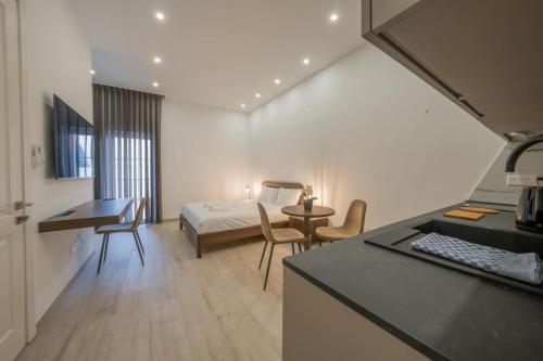 a room with a bedroom with a bed and a desk at Urban Vibe 1 in Kirkop