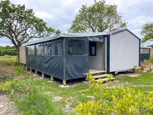 a blue tent sitting in a field in a yard at ZEcamping 3 animaux acceptés club enfant piscine couverte in Prigny