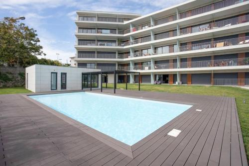 a large swimming pool in front of a building at Liiiving in Porto - Dragão Pool View in Porto