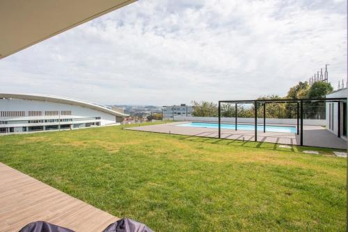 a view of the backyard of a building with a swimming pool at Liiiving in Porto - Dragão Pool View in Porto