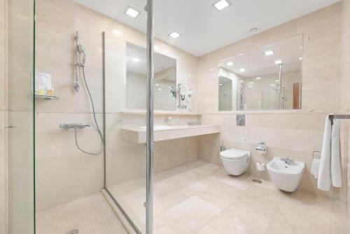 a bathroom with a shower and a toilet and a sink at Anfi del Mar Tauro Golf 1 Emerald Club in Mogán