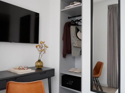 a room with a desk and a tv and a chair at Bob W London Hyde Park in London