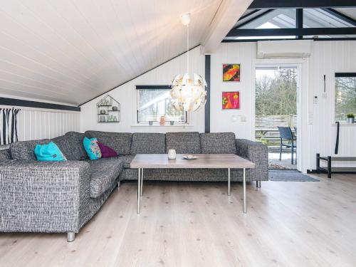 a living room with a couch and a table at 4 person holiday home in Toftlund in Toftlund