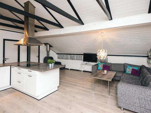 a living room with a couch and a table at 4 person holiday home in Toftlund in Toftlund