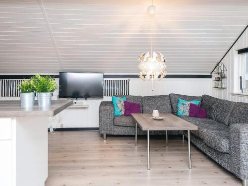 a living room with a couch and a table at 4 person holiday home in Toftlund in Toftlund
