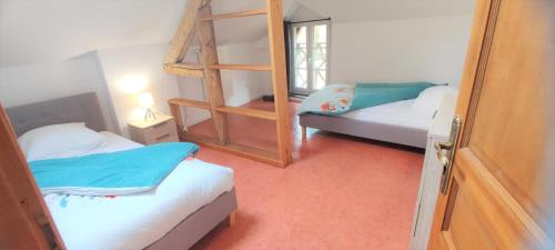 a small room with two beds and a ladder at Le haut clocher in Fumay