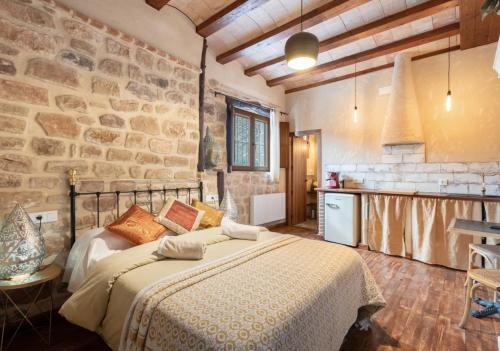 a bedroom with a bed and a stone wall at La Casuna de la Una in Olba