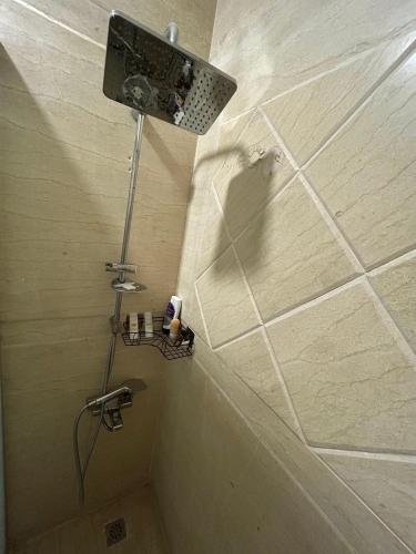 a bathroom with a shower with a light on the wall at Sea-View 1BR Apartment Balcony Full Kitchen Resort in Marsa Alam City
